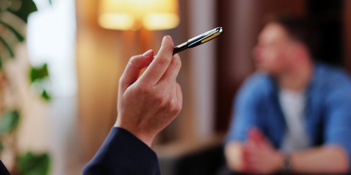 EMDR therapy — hand holding pen during bilateral stimulation session